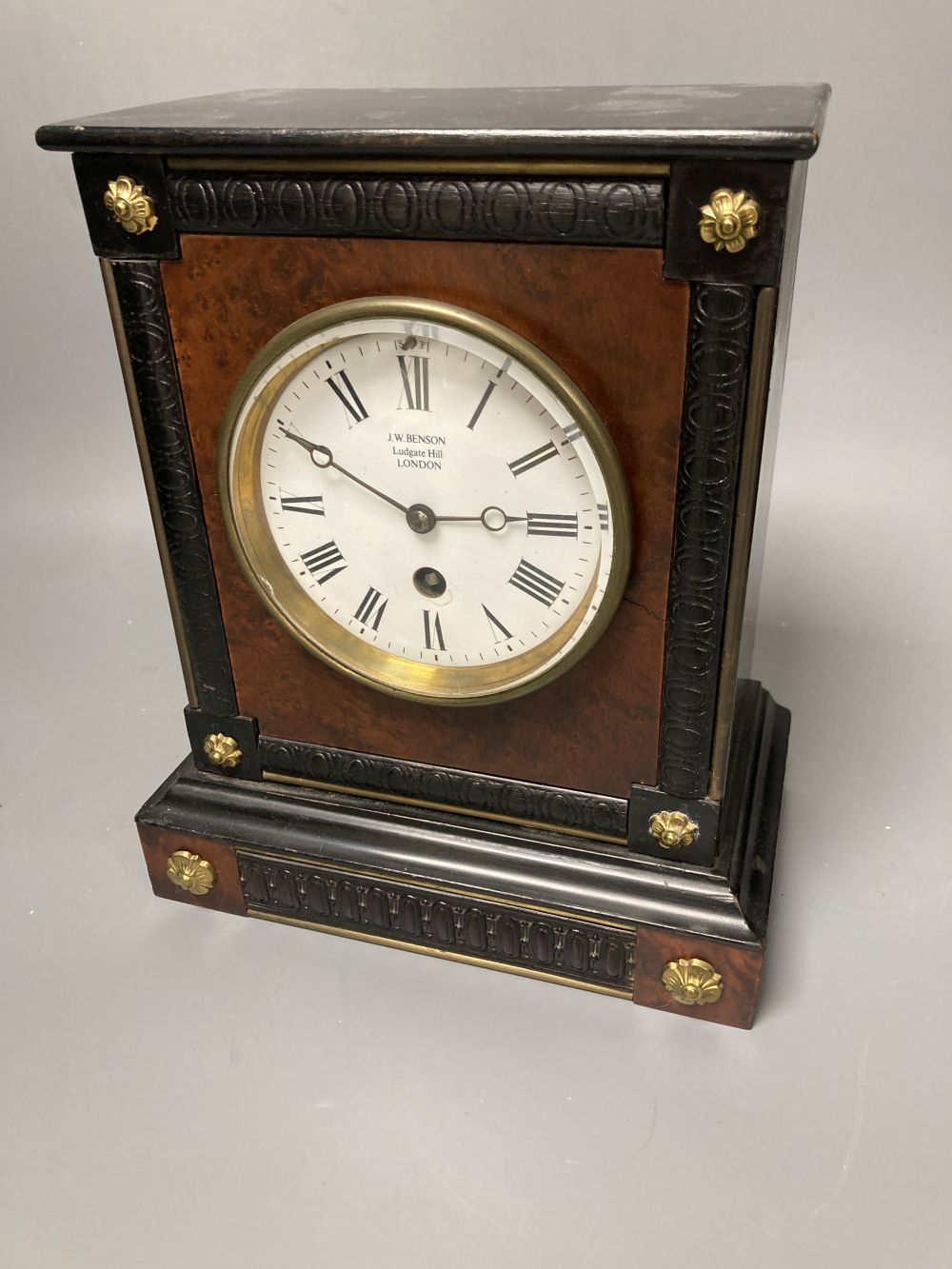 A French ebony and walnut mantel clock, height 25cm, 21cm at the base